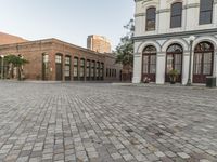 there is an empty plaza in the city square with buildings and a yellow fire hydrant