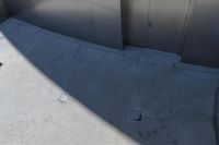 a picture of some trash cans and some tile flooring and walls outside of a building