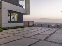 the exterior and landscape of a modern house in los angeles, california with stone and wood