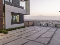 the exterior and landscape of a modern house in los angeles, california with stone and wood