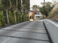 the exterior and landscape of a modern house in los angeles, california with stone and wood