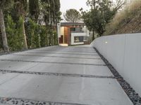 the exterior and landscape of a modern house in los angeles, california with stone and wood