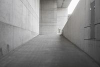 a concrete walkway with an entrance that leads to the building's roof and sides