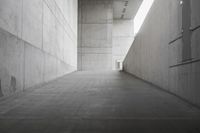 a concrete walkway with an entrance that leads to the building's roof and sides