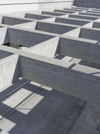 concrete blocks stacked in a complex with two open doors and a shadow cast from the floor