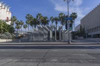 the outside view of the los county hall building, with several people walking on the sidewalk