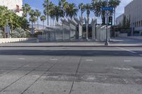 the outside view of the los county hall building, with several people walking on the sidewalk