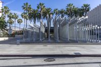 the outside view of the los county hall building, with several people walking on the sidewalk