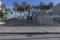 the outside view of the los county hall building, with several people walking on the sidewalk