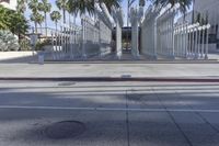 the outside view of the los county hall building, with several people walking on the sidewalk