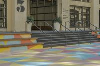 this is an image of a courtyard with multicolored tiles on the ground in front of a building