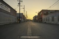a street scene with an empty street and buildings in the back ground with power lines