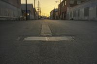 a street scene with an empty street and buildings in the back ground with power lines
