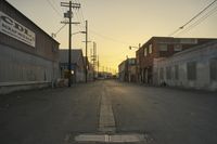 a street scene with an empty street and buildings in the back ground with power lines
