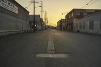 a street scene with an empty street and buildings in the back ground with power lines