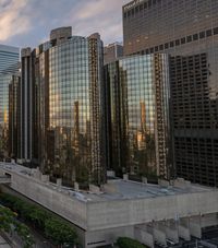 the skyscrapers are visible behind buildings in this city, at sunset time, on a cloudy day