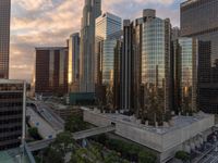 the skyscrapers are visible behind buildings in this city, at sunset time, on a cloudy day