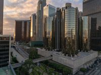 the skyscrapers are visible behind buildings in this city, at sunset time, on a cloudy day