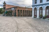 the cobblestones in an old brick road are being painted with different shades and textures