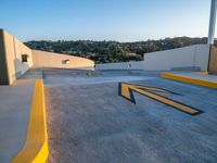 two skateboarders standing on a ramp on a building, one in black and the other in yellow