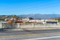 a street view showing buildings, and telephone lines, alongside the freeway with an orange line