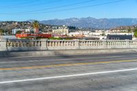 a street view showing buildings, and telephone lines, alongside the freeway with an orange line