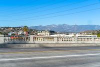 a street view showing buildings, and telephone lines, alongside the freeway with an orange line