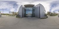 a building is surrounded by large circular mirrors that capture time lapsing and 360 photography