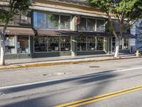 a motorcycle is parked on the side of a street in front of a storefront