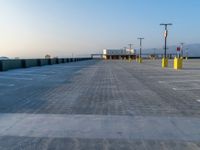 a empty parking lot and the sky is blue and cloudless, at dusk time