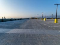 a empty parking lot and the sky is blue and cloudless, at dusk time