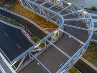 a view of a road and an overpass with traffic passing through it by buildings