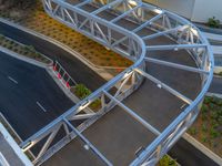 a view of a road and an overpass with traffic passing through it by buildings