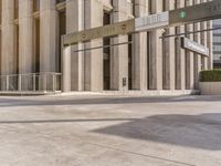 the entrance of an empty building is seen on a sunny day in this city street