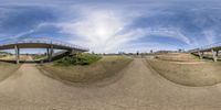 a large curved glass panorama of various things on the grass ground and overpasses