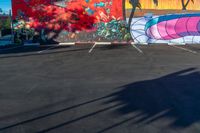 an empty parking lot is painted with colorful graffiti art and palm trees on the sides