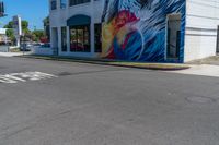 this is a street corner of a city street with the painting of a eagle on it