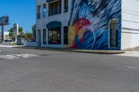 this is a street corner of a city street with the painting of a eagle on it