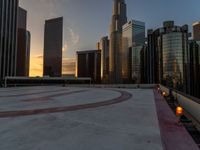 the sun is setting in downtown on the roof of an office building with tall buildings