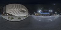 an image of a building that is inside a circle at night time that appears to be circular