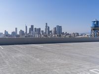 a skateboarder performing tricks on top of an old building on a roof, with tall buildings behind him