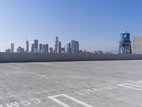 a skateboarder performing tricks on top of an old building on a roof, with tall buildings behind him