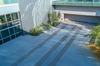 the outside of a building with stairs and a tree in front of it, as seen from above