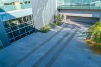 the outside of a building with stairs and a tree in front of it, as seen from above