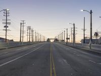 a empty highway runs down the side of a bridge to the other side of the street