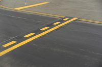 a person is crossing a street on a crosswalk on the road near an airport