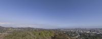 a hill with hills and trees around it under blue sky and clouds in los angeles, california