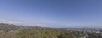 a hill with hills and trees around it under blue sky and clouds in los angeles, california