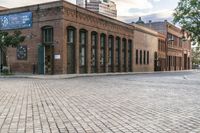 the large brick building has two rows of windows on one side and several windows on the other