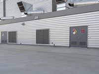 an image of the industrial building of a factory or industrial complex with many vent hoods